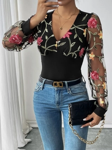 Close-up of floral embroidery on black sheer mesh long sleeve bodysuit for women