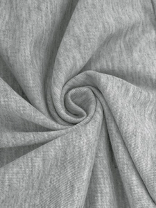 Macro shot of light gray heather knit fabric texture with soft spiral draped patterns