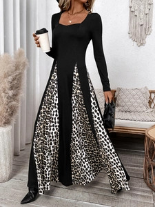 Detail of square neck and leopard print paneling on a black long-sleeve maxi dress