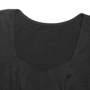 Detail shot of the layered neckline design on a black knit dress with clean stitching