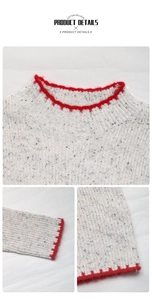 Detail of grey ribbed knit sweater with vibrant red fuzzy trim on neckline and cuffs
