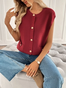 Detail of burgundy knit vest featuring gold metallic buttons and side pocket accents