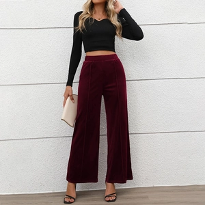 Women's burgundy velvet wide-leg trousers paired with black V-neck crop top outfit