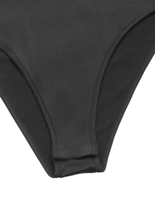 Close-up detail of three rows of snap buttons on the black mesh bodysuit crotch