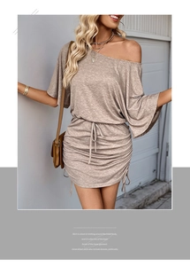 Detail of light brown off-shoulder dress featuring side drawstrings and ribbed fabric texture