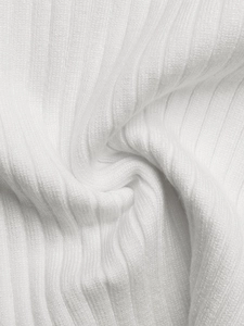 Detailed macro view of white ribbed knit fabric texture with vertical elastic patterns