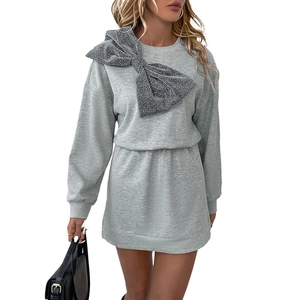 Grey long sleeve dress with a large sparkling silver bow on the shoulder for a chic party look