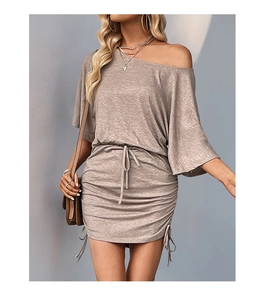 Detail of drawstring ruching and tie-up details on light brown off-shoulder dress