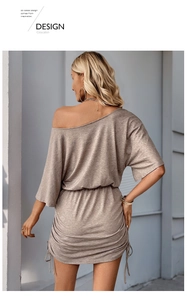 Detail view of the soft knitted fabric and adjustable side drawstring of the dress