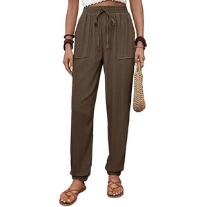 Dettaglio dei pantaloni casual marrone caffè con vita elastica a coulisse e tasche laterali