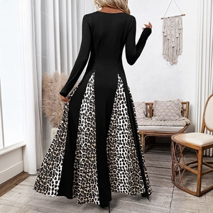 Elegant long sleeve maxi dress featuring black fabric and side leopard print panels