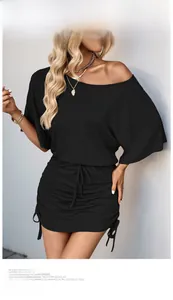 Close-up of the black off-shoulder dress featuring adjustable side drawstring and ruched texture