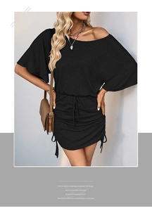 Detail of black off-shoulder mini dress with drawstring ruched sides and knit texture