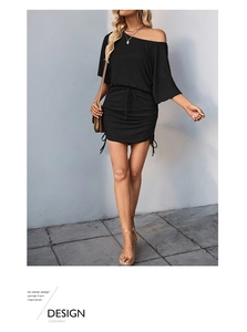 Detail of the side drawstring and ruching texture on this black one-shoulder dress