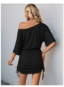 Back view of a black off-shoulder dress featuring ruched details and side drawstring design