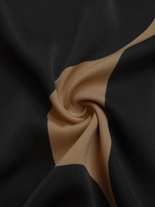 Macro view of geometric black and tan fabric showing fine plain weave texture