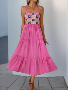 Detail of fuchsia halter neckline with yellow and navy geometric print and gold necklace