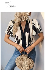 Detail of V-neck bodysuit with black and white abstract geometric ink print and ruffles