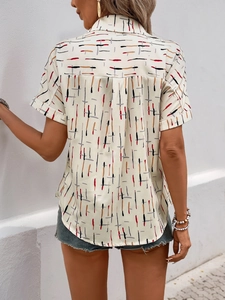 Detail view of the back pleat and abstract geometric print on a short-sleeve shirt