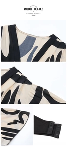 Detail view of V-neckline with pleated shoulders and metal snap closure at the bottom