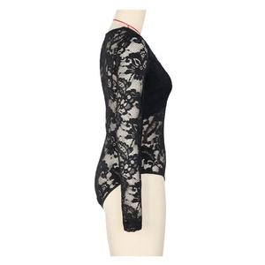 Detail of delicate floral lace fabric and sheer long sleeve design on black bodysuit