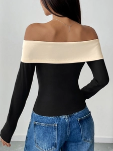 Detail view of the contrast trim off-the-shoulder long sleeve top from the back