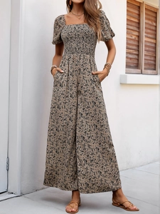 Detail of smocked square neck and puff sleeves on floral wide-leg summer jumpsuit