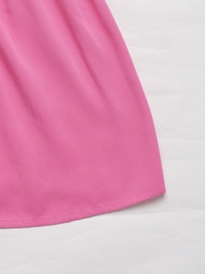 Close-up of rose pink twill fabric texture and stitching detail of halter dress