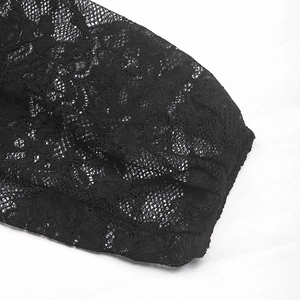 Macro detail of intricate floral lace patterns and sheer mesh on the black bodysuit