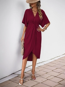 Detail of burgundy V-neck dress with twist-knot waist and asymmetric wrap skirt