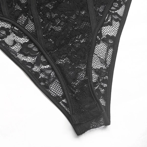 Close-up of black floral lace and mesh texture with reinforced edges on the bodysuit