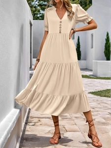 Detail of cream short-sleeve tiered maxi dress with V-neck and button-down front