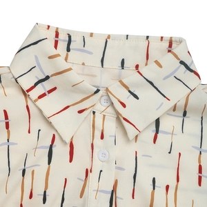 Detailed close-up of classic pointed collar and colorful abstract line print on the shirt