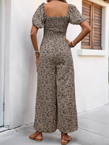 Detail of the elastic smocked back and floral print on a square-neck summer jumpsuit
