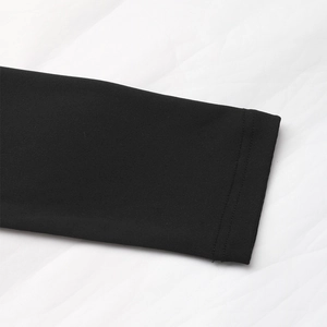 Close-up of fine knitted black fabric with neat double-needle stitching on the sleeve cuff