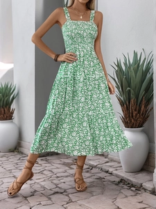 Detailed view of green floral tiered summer dress with smocked bodice and wide straps