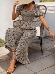 Detail of square neck smocked jumpsuit with floral print and puffy sleeves