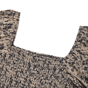 Close-up of square neck with smocking detail and floral print on khaki summer jumpsuit