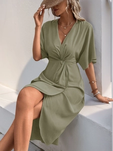 Detail of olive green V-neck dress with knot waist and silky satin texture fabric