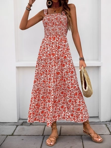 Detail of red floral maxi dress showing smocked bodice and delicate spaghetti straps