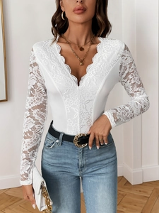 Close-up of intricate floral lace detailing on white V-neck long sleeve bodysuit