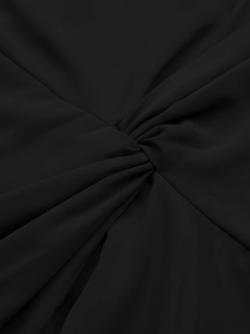 Close-up detail of the twist-knot design on a smooth black asymmetric evening dress