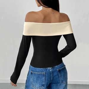 Off-shoulder black long sleeve top with cream bow detail and contrast fold design