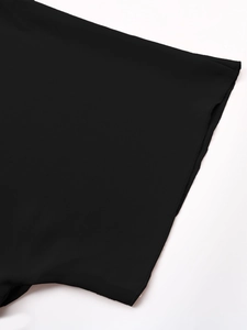 Close-up of black dress fabric with detailed industrial overlock stitching on the hem