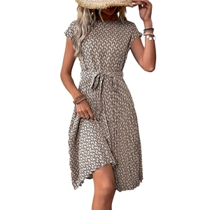 Elegant summer dress featuring a geometric chain print, tie waist, and pleated skirt design