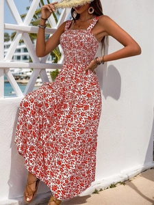 Detail of red floral maxi dress with smocked bodice and tiered skirt for summer resort