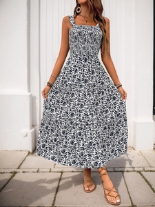 Detail of smocked bodice and tiered floral print long dress for summer beach vacations