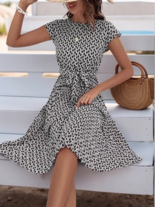 Detail of summer A-line dress with geometric print, crew neck and matching waist belt