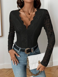 Detail of elegant V-neck lace bodysuit with sheer long sleeves and eyelash trim