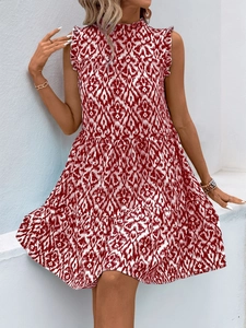 Detailed view of red and white printed sleeveless dress with ruffled layers and high neck